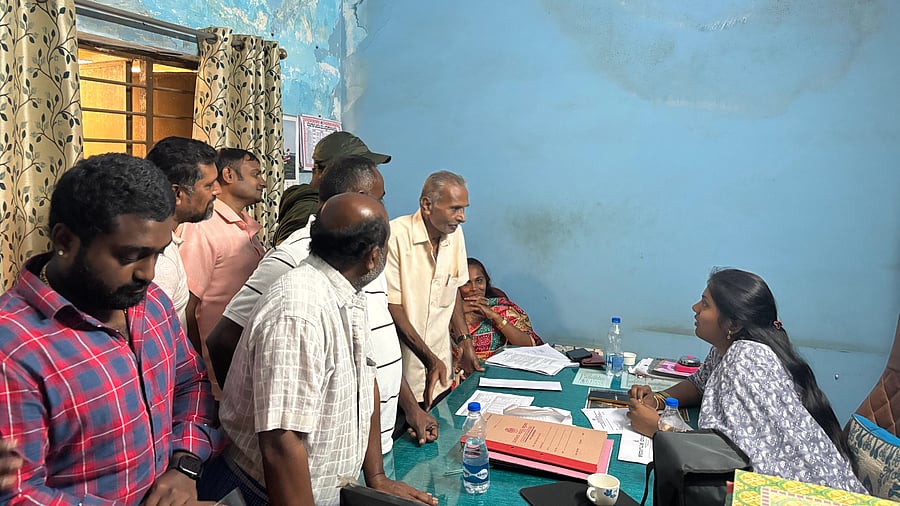 <div class="paragraphs"><p>Landowners meet a land acquisition officer to voice their objections to the compensation offer. </p></div>