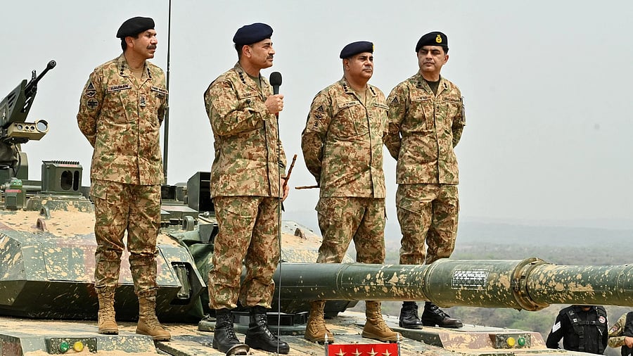 <div class="paragraphs"><p>Chief of Army Staff of Pakistan Asim Munir holds a microphone during a high-intensity field training exercise conducted by the Pakistan Army.</p></div>