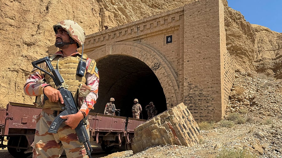 <div class="paragraphs"><p>Pakistan army soldiers stand at a tunnel.</p></div>