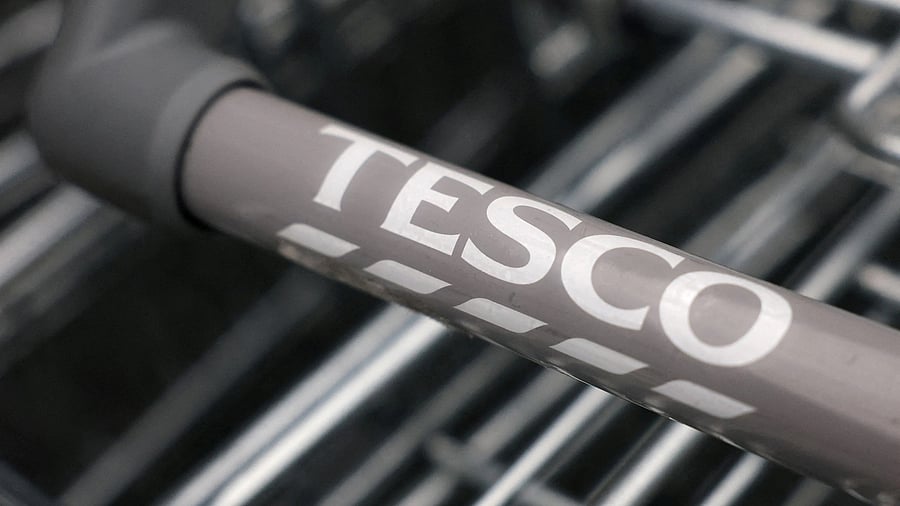 <div class="paragraphs"><p> Tesco branding is seen on a trolley </p></div>