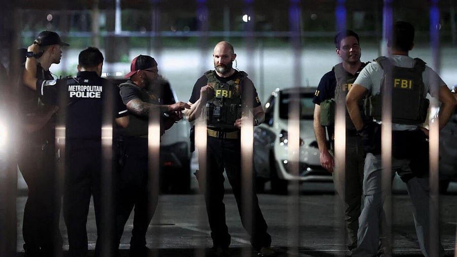 <div class="paragraphs"><p>FBI agents and a Metropolitan Police officer talk in a parking lot near Howard University, after US President Donald Trump's announcement to deploy the National Guard and federalize the Metropolitan Police Department in Washington, DC, US.</p></div>