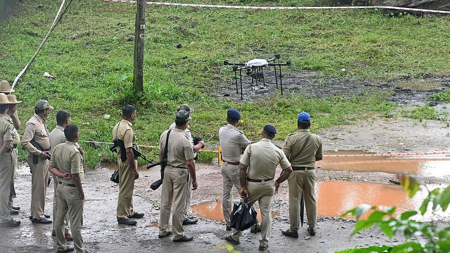 <div class="paragraphs"><p>Police officials at the alleged burial site.</p></div>