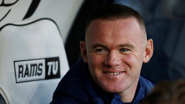 <div class="paragraphs"><p>Derby County player coach Wayne Rooney watches a match.</p></div>