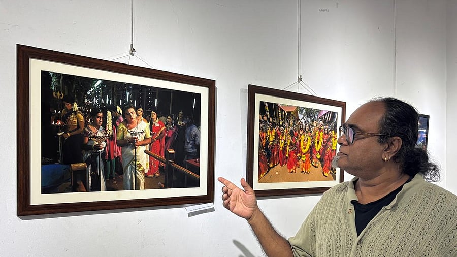 Photographer-artist Pramod Stephen explains one of his works, which showcases cross-dressing at a temple at Kollam, Kerala, where men dress up as women to offer prayers as part of a ritual and devotion to the deity.