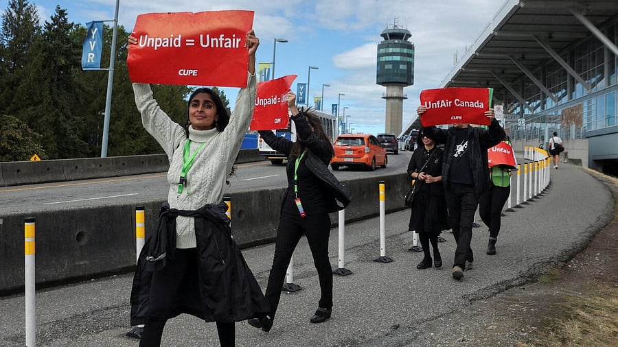<div class="paragraphs"><p>Demonstrators hold placards on the day the strike begins, after the union representing more than 10,000 of Air Canada's flight attendants failed to reach an agreement with the airline, at Vancouver International Airport in Richmond, British Columbia, Canada, August 16, 2025.</p></div>