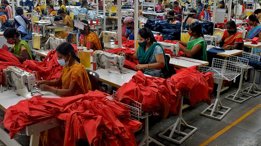 <div class="paragraphs"><p>Garment workers stitch shirts at a textile factory.</p></div>