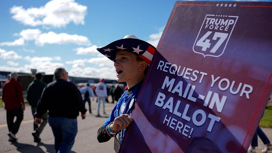 <div class="paragraphs"><p>File photo of a person holding a sign asking people to request their mail-in ballot.&nbsp;</p></div>