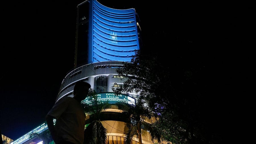 <div class="paragraphs"><p>A man walks past the lit up Bombay Stock Exchange (BSE) building</p></div>