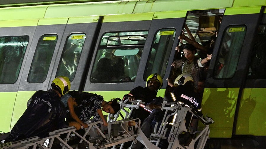 <div class="paragraphs"><p>Passengers being rescued after a Monorail train came to a halt between Mysore Colony and Bhakti Park stations due to apparent power failure during rainfall, in Mumbai, Tuesday, Aug. 19, 2025.</p></div>
