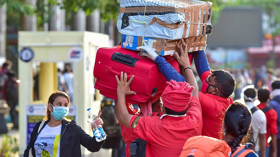 <div class="paragraphs"><p>Railway porters (coolie) carry luggage of passengers arriving at a railway station  in Bengaluru. </p></div>