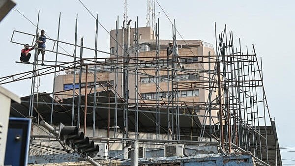 <div class="paragraphs"><p>Workers at a construction site in Bengaluru.&nbsp;</p></div>