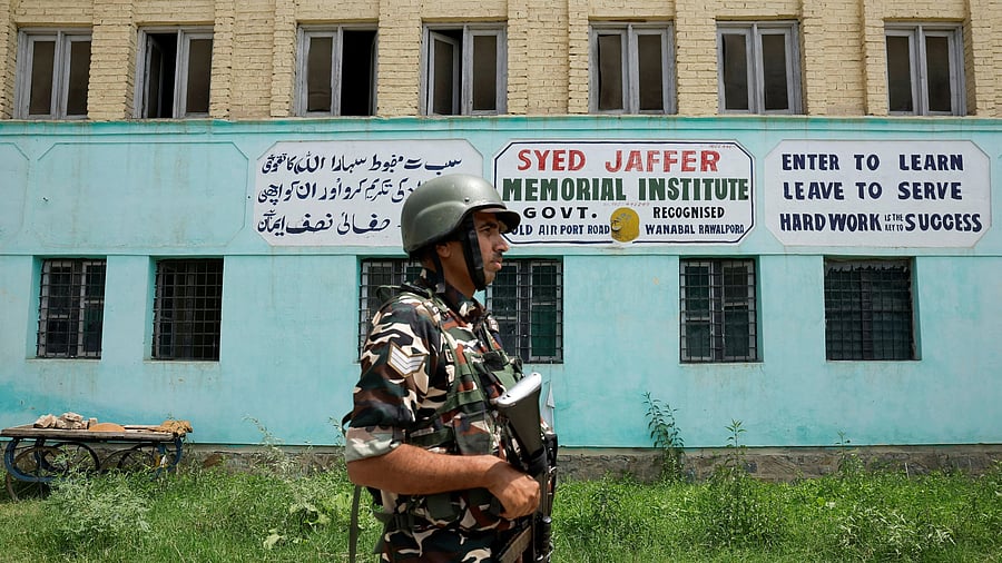 <div class="paragraphs"><p>File photo: A member of Indian security forces patrols outside Syed Jaffer Memorial School, run by Falah-e-Aam Trust (FAT), an affiliate of Kashmir-based Islamist political party Jamaat-e-Islami (JeI) that New Delhi banned in 2019.</p></div>