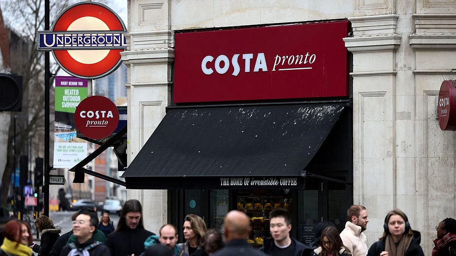 <div class="paragraphs"><p>People walk outside a Costa coffee shop in London.</p></div>