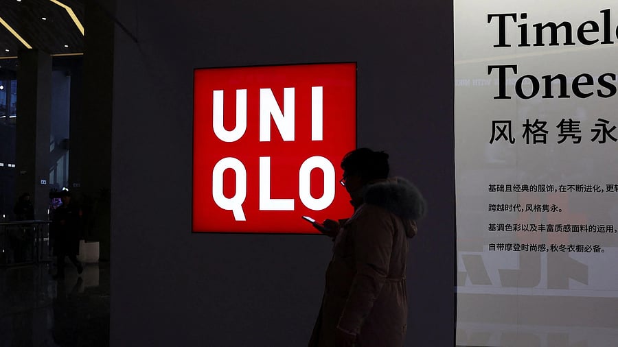 <div class="paragraphs"><p>A woman walks past a store of Fast Retailing's fashion chain Uniqlo</p></div>