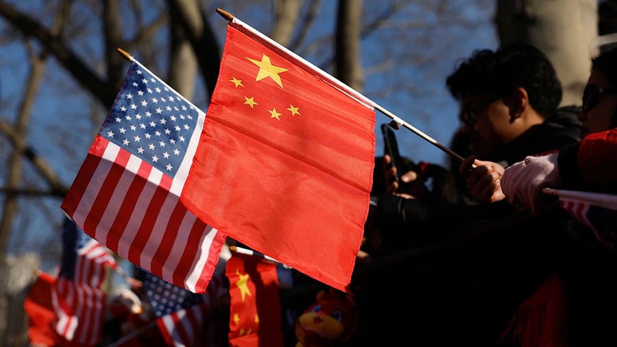<div class="paragraphs"><p>People hold US and China flags</p></div>