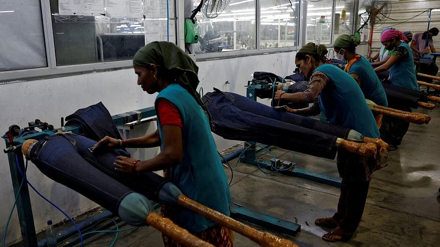 <div class="paragraphs"><p>Workers use sand paper on jeans to fade colour in a garment manufacturing unit on the outskirts of Ahmedabad.</p></div>