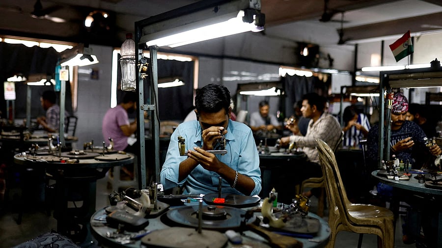<div class="paragraphs"><p>Craftsmen work on diamonds inside a diamond processing unit in Surat. </p></div>