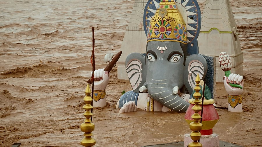 <div class="paragraphs"><p>Water from the overflowing Tawi River floods a temple of Lord Ganesh following heavy rain in Jammu.</p></div>