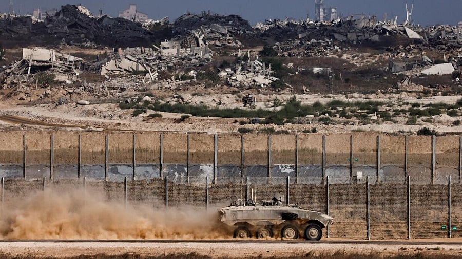<div class="paragraphs"><p>An Israeli armoured personnel carrier (APC) manoeuvres on the Israeli side of the border with Gaza, as seen from Israel.</p></div>