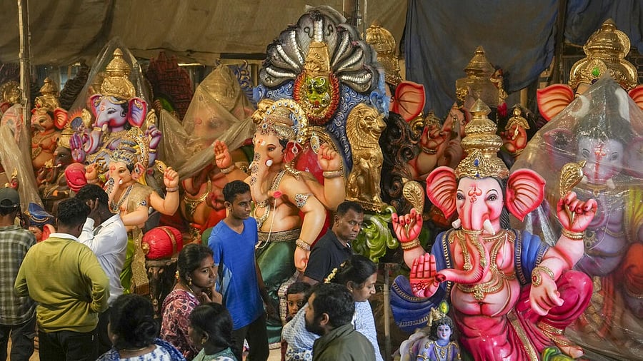 <div class="paragraphs"><p>People look at the idols of Lord Ganesh at a workshop on the eve of the ‘Ganesh Chaturthi’ festival, in Bengaluru.</p></div>
