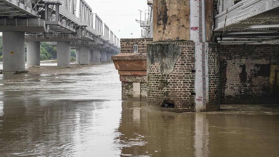<div class="paragraphs"><p>The swollen Yamuna river during the monsoon season, near Kashmere Gate area in New Delhi, Tuesday, Aug. 26, 2025. The Yamuna river crossed the warning mark of 204.50-metre at the Old Railway Bridge on Tuesday morning.</p></div>