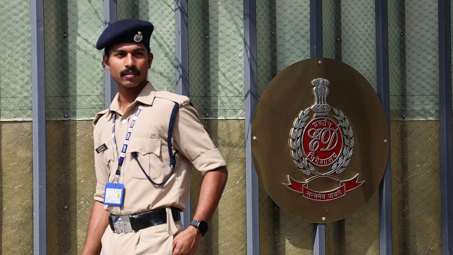 <div class="paragraphs"><p>A security personnel walks past a gate of the office of Directorate of Enforcement in New Delhi.</p></div>