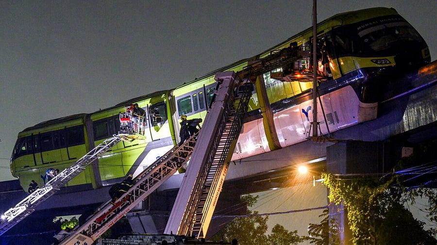 <div class="paragraphs"><p>Passengers being rescued after a Monorail train came to a halt between Mysore Colony and Bhakti Park stations due to apparent power failure during rainfall, in Mumbai, Tuesday, Aug. 19, 2025.</p></div>