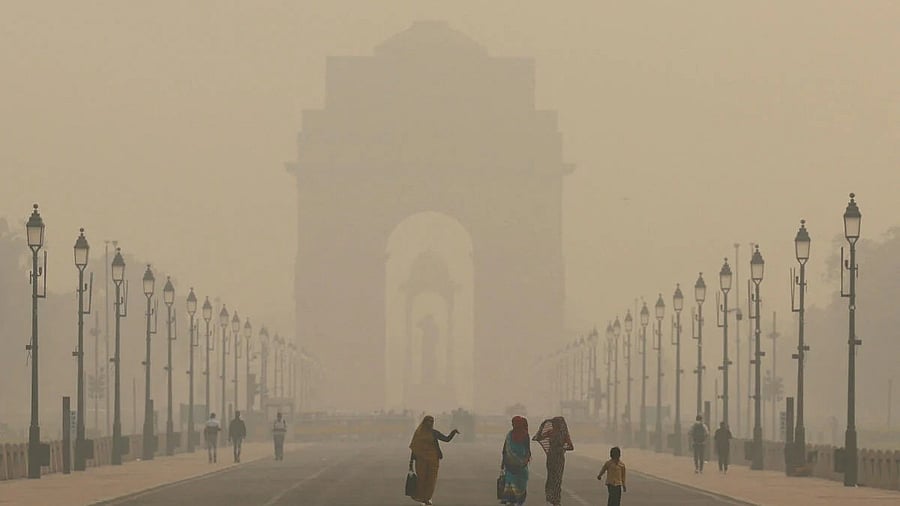 <div class="paragraphs"><p>Women walk on a road near India Gate as the sky is enveloped with smog after Delhi's air quality worsened due to air pollution, in New Delhi.</p></div>