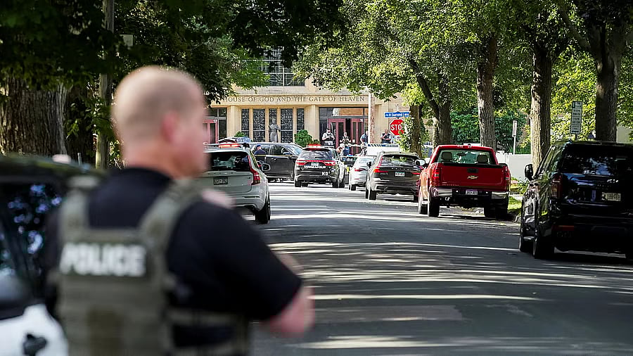 <div class="paragraphs"><p>Law enforcement officers gather outside Annunciation Church following a mass shooting event, in Minneapolis, Minnesota, US, August 27, 2025. </p></div>