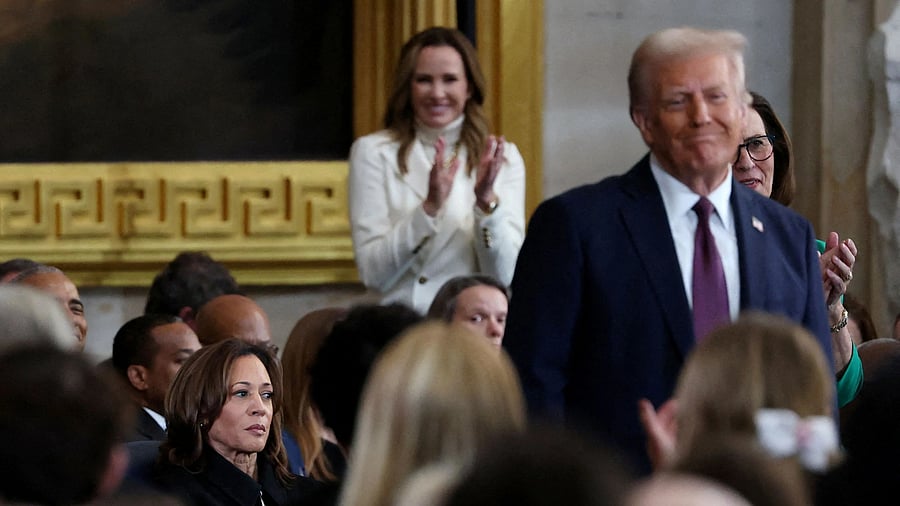 <div class="paragraphs"><p>Former US Vice President Kamala Harris looks on as US President Donald Trump receives applause.</p></div>