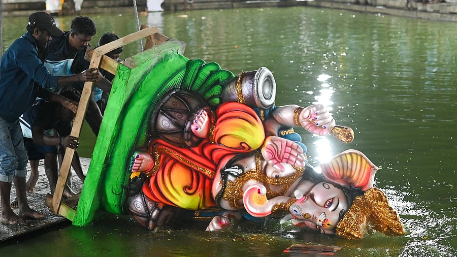 <div class="paragraphs"><p>BBMP workers immerse a Ganesha idol in Ulsoor Lake on Friday. </p></div>