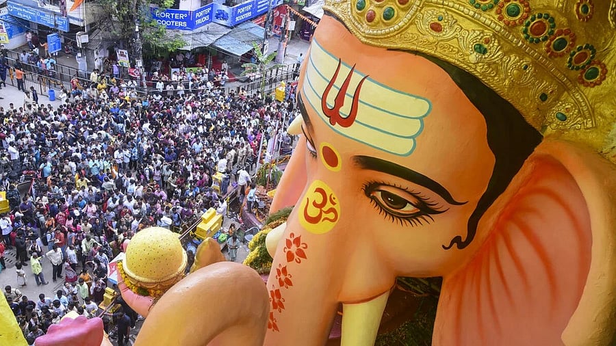 <div class="paragraphs"><p>People gather to offer prayers to a 69-feet tall idol of Lord Ganesha at a pandal during the ‘Ganesh Chathurthi’ festival, at Khairatabad, in Hyderabad, Telangana</p></div>