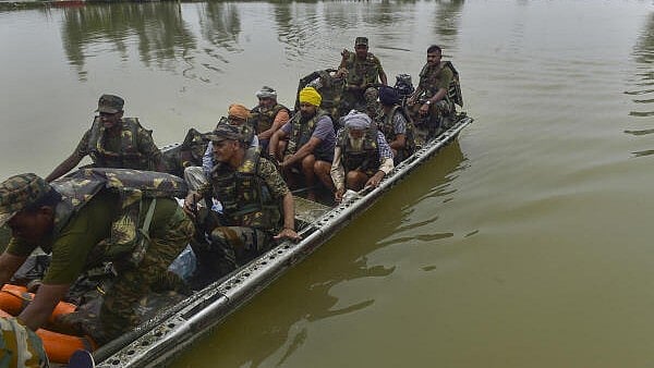 <div class="paragraphs"><p>Army personnel during a rescue and evacuation operation at a flood-affected village.</p></div>