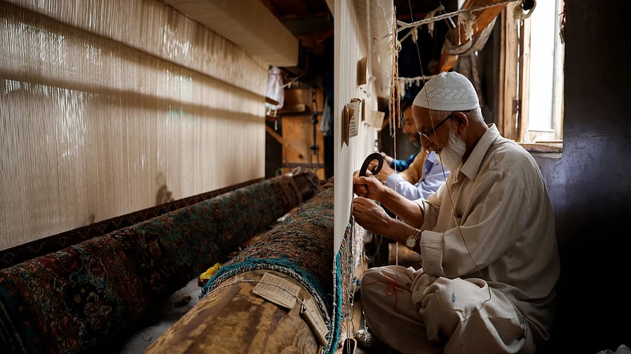 <div class="paragraphs"><p>Ghulam Qadir, 75, weaves a Kashmiri hand-knotted carpet inside his workshop in Srinagar, Indian Kashmir, August 26, 2025. </p></div>