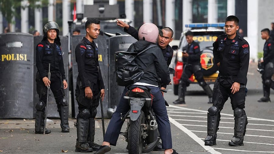 <div class="paragraphs"><p>Riot police inspect a motorist outside Indonesian parliament building, amid the widespread anti-government protests and rioting over issues such as extra pay for parliamentarians and housing allowances led by student group that resulted into riots rocked Southeast Asia's largest economy, in Jakarta, Indonesia, August 31, 2025.</p></div>
