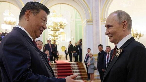 <div class="paragraphs"><p>Russian President Vladimir Putin shakes hands with Chinese President Xi Jinping during a reception.</p></div>