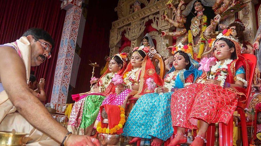 <div class="paragraphs"><p>A priest performs 'Kumari Puja' on the occasion of 'Maha Ashtami' during Durga Puja festival, in Balurghat. </p></div>