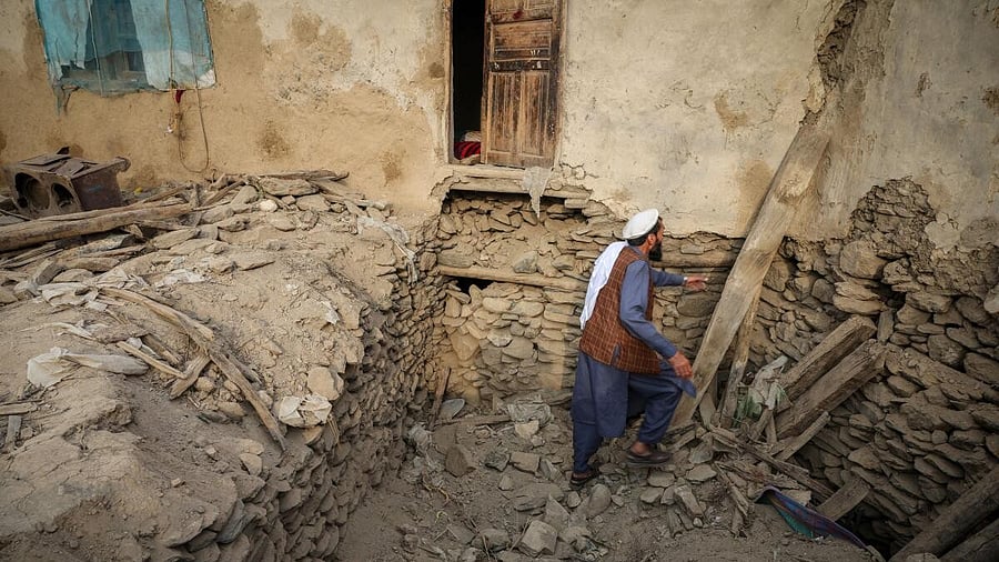 <div class="paragraphs"><p>An Afghan man looks for his belongings amidst the rubble of a collapsed house after a deadly magnitude-6 earthquake that struck Afghanistan around midnight, in Dara Noor, in Jalalabad, Afghanistan.</p></div>