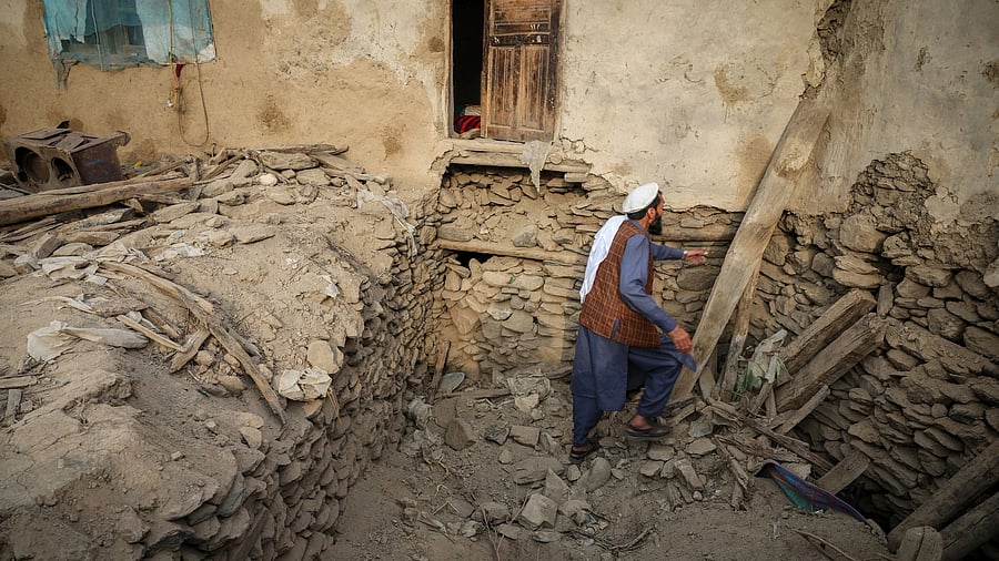 <div class="paragraphs"><p>An Afghan man looks for his belongings amidst the rubble of a collapsed house after a deadly magnitude-6 earthquake that struck Afghanistan around midnight, in Dara Noor, in Jalalabad, Afghanistan</p></div>