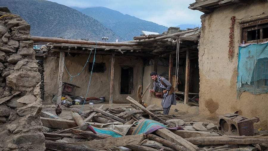 <div class="paragraphs"><p>An Afghan man looks for his belongings amidst the rubble of a collapsed house after earthquake struck Afghanistan </p></div>