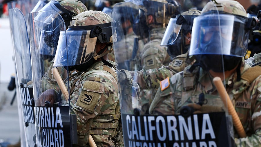 <div class="paragraphs"><p>National Guard troops wear gas masks during protests against federal immigration sweeps, in Los Angeles, California, US.</p></div>