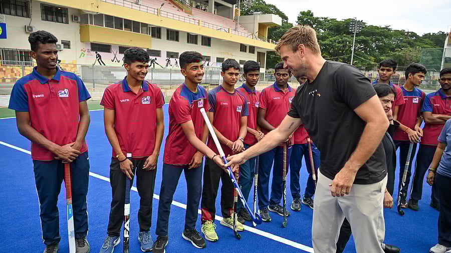 <div class="paragraphs"><p>Olympic gold medallist Moritz Furste greets young hockey players at the Hockey Stadium in Bengaluru on Tuesday. </p></div>