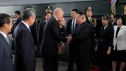 <div class="paragraphs"><p>Kim Jong Un walking and being greeted next to his daughter Kim Ju Ae by Director of the General Office of the Chinese Communist Party (CCP) Cai Qi, after his arrival in Beijing, China.</p></div>