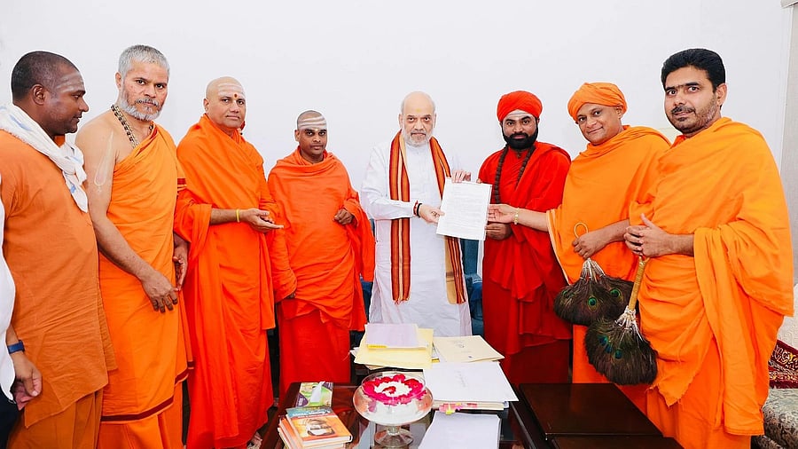 Seers of various mutts meet Union Home Minister Amit Shah in New Delhi on Wednesday and submit a memorandum seeking a National Investigation Agency (NIA) probe into the Dharmasthala case.