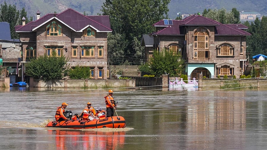 <div class="paragraphs"><p>Families evacuated as part of a rescue and search operation after the water level in the Jhelum river overflows following incessant rainfall, in Budgam, Jammu and Kashmir.</p></div>