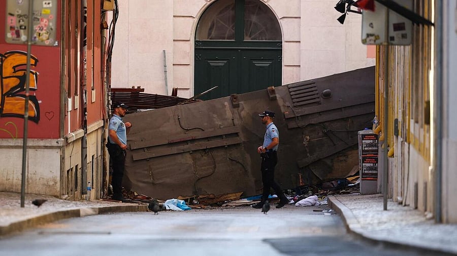 <div class="paragraphs"><p>Police officers stand near the site of the accident after Gloria funicular railway car, a popular tourist attraction, derailed and crashed, resulting in multiple casualties, according to authorities, in Lisbon, Portugal,</p></div>