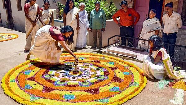 <div class="paragraphs"><p>Young women prepare a 'Pookalam' during celebrations of the Onam festival.</p></div>
