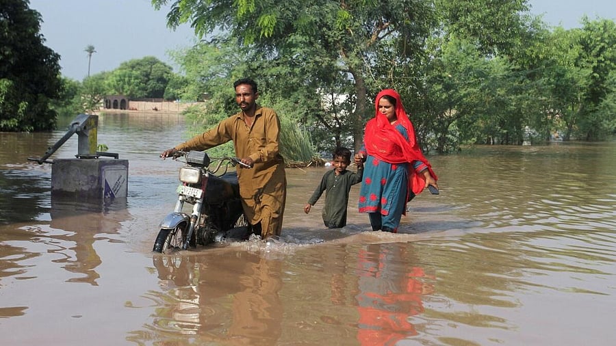 <div class="paragraphs"><p>Residents wade through a flooded road following monsoon rains and rising water levels of the Chenab River, in Muzaffargarh, Punjab province, Pakistan September 5, 2025.</p></div>