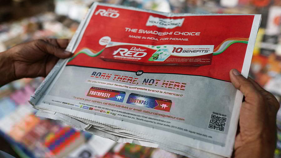 <div class="paragraphs"><p>A person poses with The Times of India newspaper, dated 1st September 2025, featuring a "Made in India" advertisement by Dabur India Limited, one of the leading Indian consumer goods company at a news-stand in New Delhi, India, September 5, 2025. </p></div>