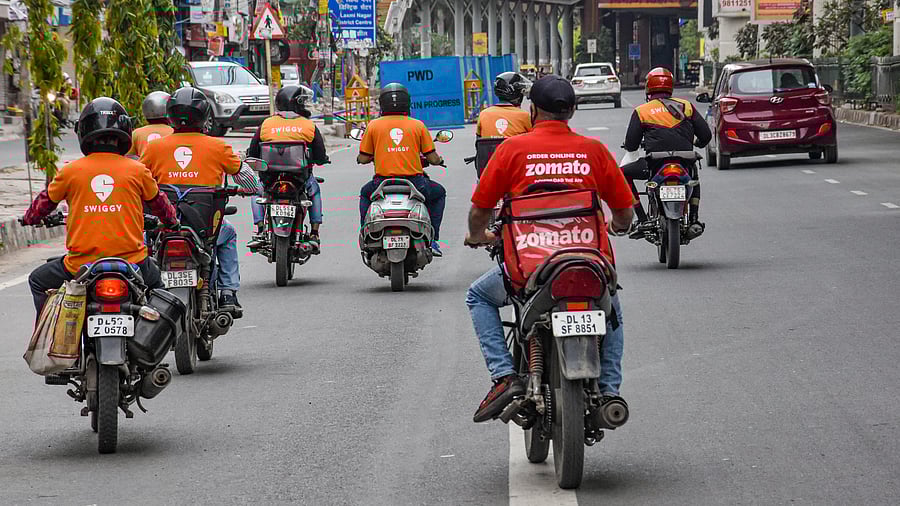 <div class="paragraphs"><p>File photo of deliverymen of food aggregators Swiggy and Zomato ride their bikes towards their destinations</p></div>